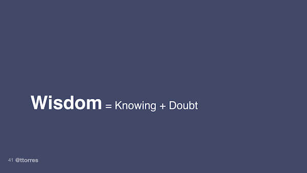 The text "wisdom = knowing + doubt"